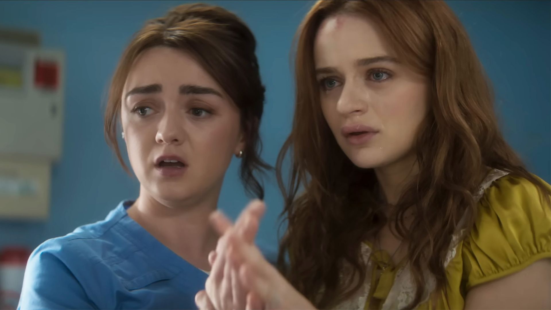 Maisie Williams and Joey King lace hands in what looks to be a hospital setting in Practical Magic 2.