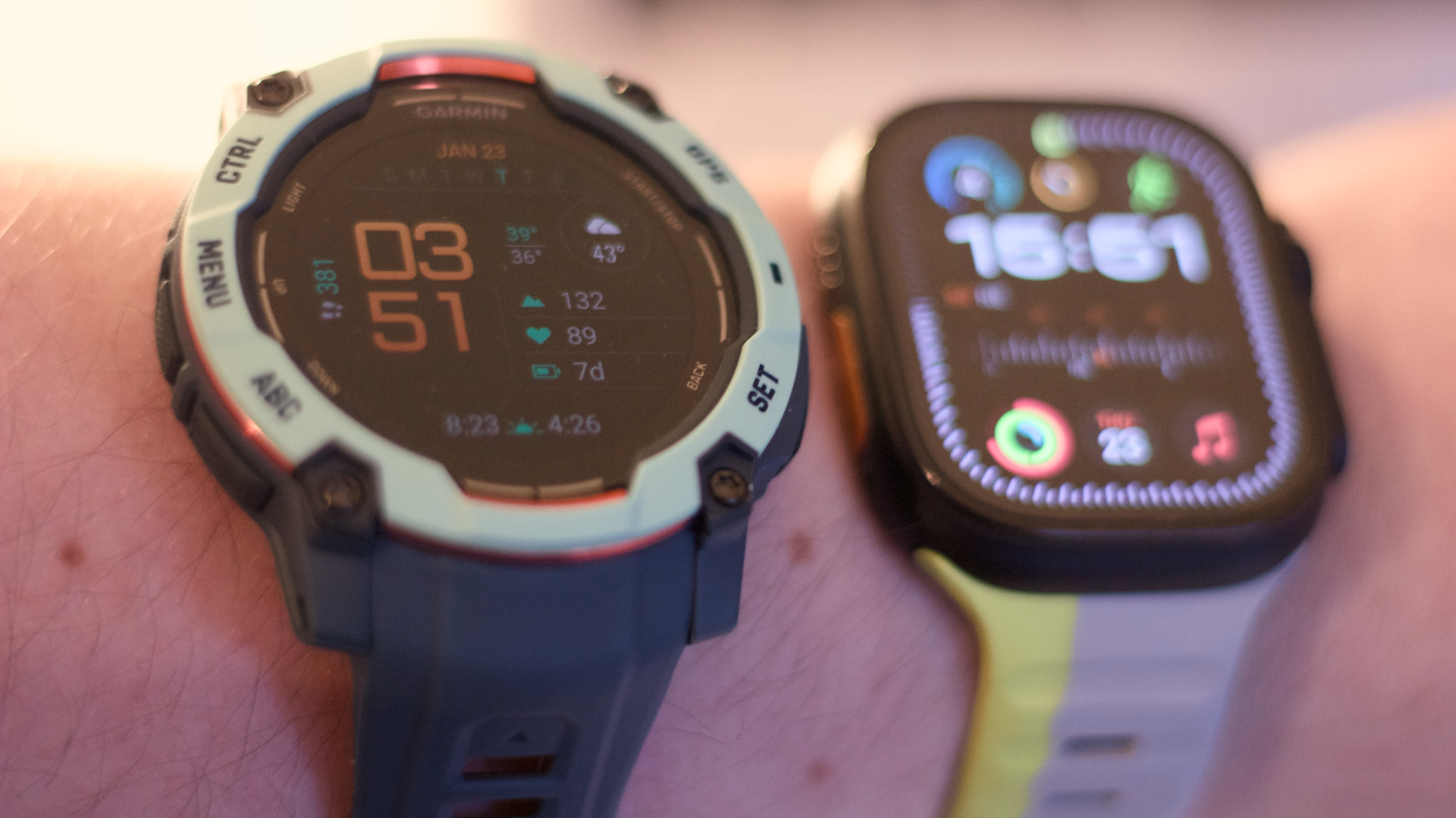 Garmin Instinct 3 next to the Apple Watch Ultra 2