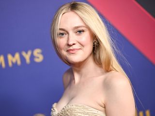 Dakota Fanning wears a strapless champagne gown by Armani Privé on the 2024 Emmys red carpet.