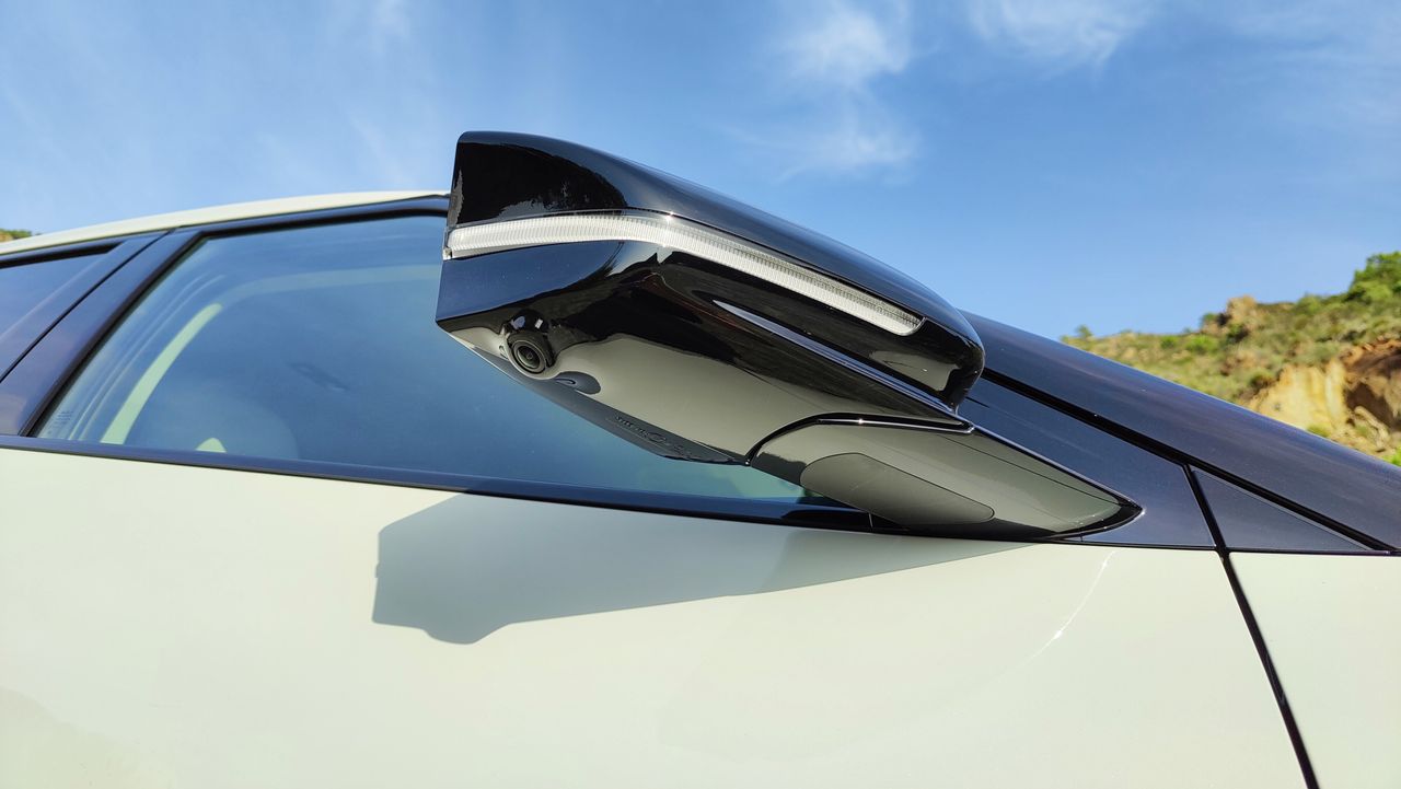 Underside of a wing mirror showing a base mounted camera
