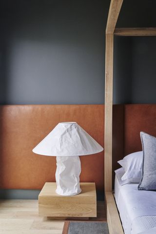 a paper lamp on a nightstand