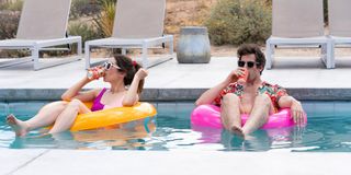 Palm Springs Sandberg and Milioti float in a pool