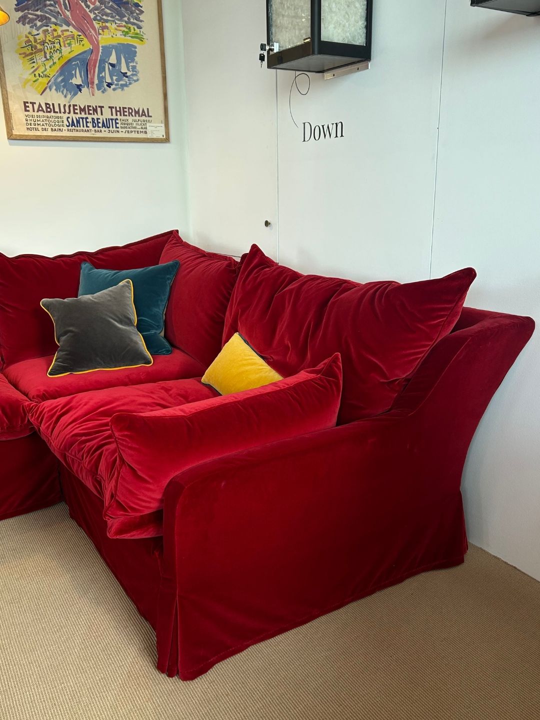 The Vesper sofa in deep red Pinot Cotton Velvet, showing the redesigned lower arm, smaller arm cushion, deep seating and tailored skirt.