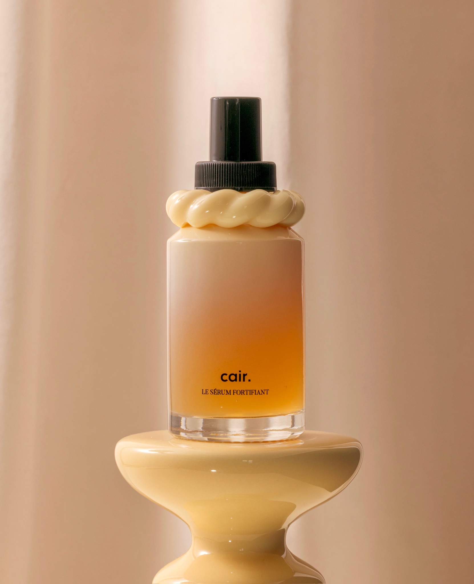 Cair hair care serum in glass ombre bottle