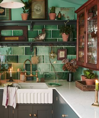 devol kitchen with green tiles and open shelving with a vintage wall cabinet