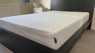 The Zinus Memory Foam Mattress on a bed frame in a bedroom