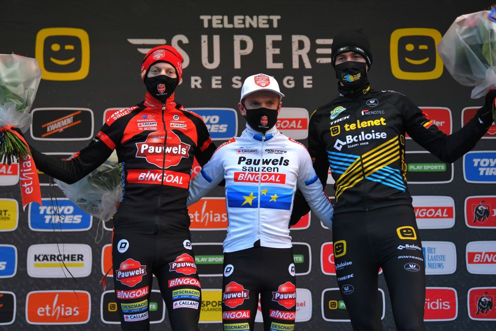 BOOM BELGIUM DECEMBER 06 Podium Michael Vanthourenhout of Belgium and Team Pauwels Sauzen Bingoal Eli Iserbyt of Belgium and Team Pauwels Sauzen Bingoal Toon Aerts of Belgium and Team Telenet Baloise Lions Celebration Flowers Mask Covid Safety Measures during the 6th Superprestige Cyclocross Boom 2020 Men Elite De Schorre Boom Superprestige2021 SPBoom SuperprestigeCX on December 06 2020 in Boom Belgium Photo by Luc ClaessenGetty Images