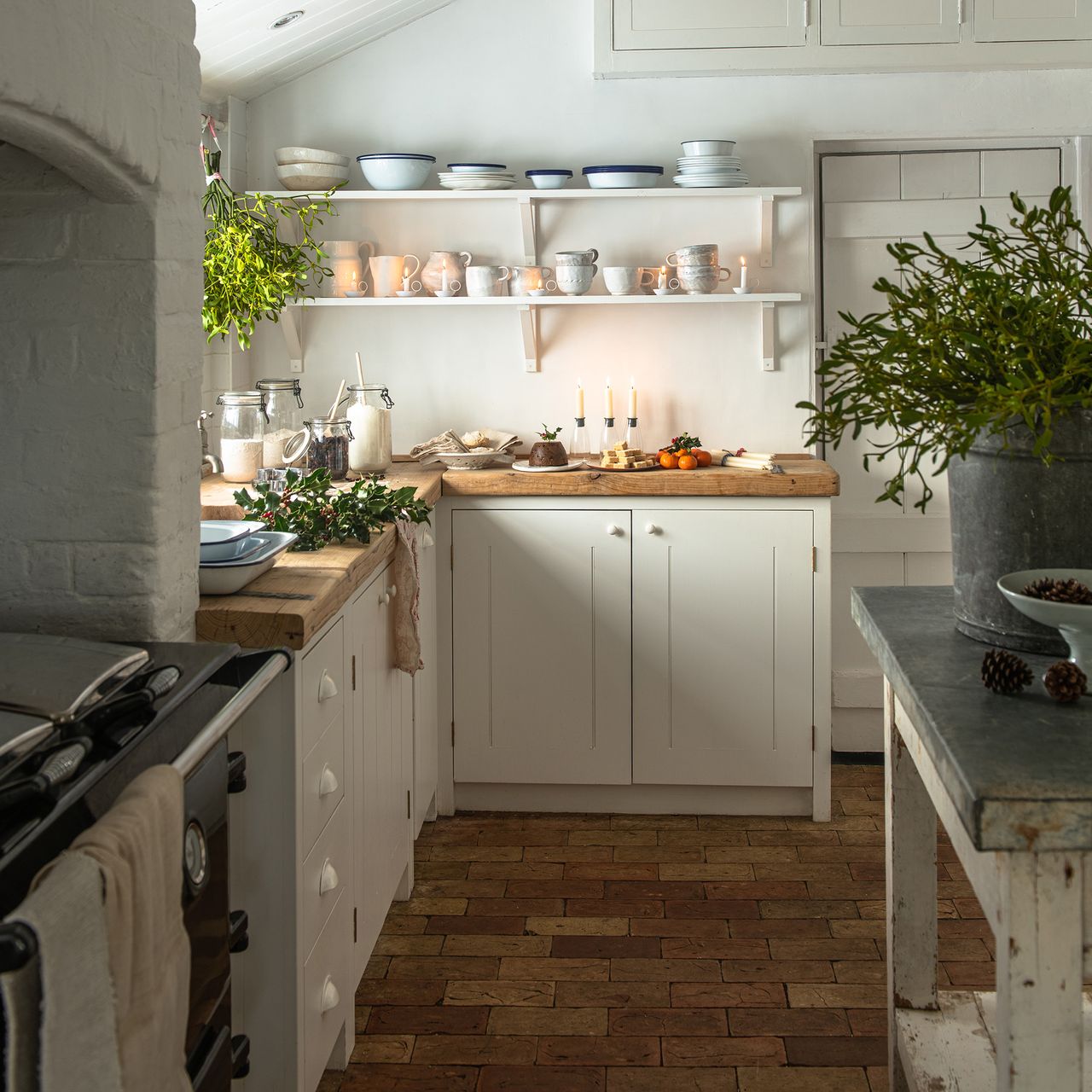 neutral kitchen with cream cabinets and wooden worktops dressed for christmas with mistletoe and festive foliage 1