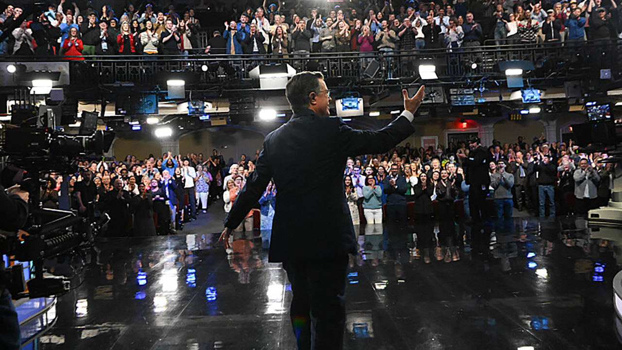 Stephen Colbert steps out onto the Late Show stage and waves at the audience one final time. 