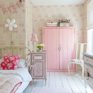 pink bedroom with wallpaper and wardrobe