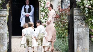 The Princess of Wales leads the page boys and bridesmaids as they arrive at the wedding of Pippa Middleton and James Matthews