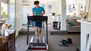 Man running on home treadmill