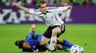 DORTMUND, GERMANY - JULY 04: Mauro Camoranesi of Italy falls to the ground after the challenge of Philipp Lahm of Germany during the FIFA World Cup Germany 2006 Semi-final match between Germany and Italy played at the Stadium Dortmund on July 04, 2006 in Dortmund, Germany. (Photo by Alex Livesey/Getty Images)