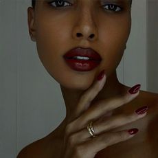 Jasmine Tookes with red polish and red lipsticj