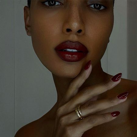 Jasmine Tookes with red polish and red lipsticj