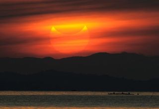 A partial solar eclipse as seen during sunrise in the coastal town of Gumaca, in the Philippines, on May 21, 2012. 