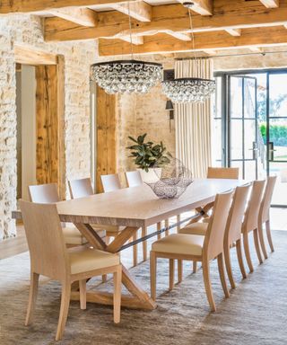 Dining room with wooden ceiling and wooden central table and chairs