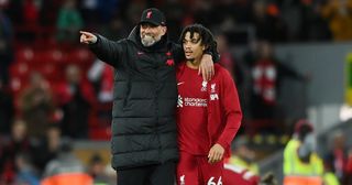 Liverpool manager Jurgen Klopp speaks with Trent Alexander-Arnold of Liverpool after their side's victory in the Premier League match between Liverpool FC and Wolverhampton Wanderers at Anfield on March 01, 2023 in Liverpool, England.