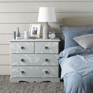 bedroom with grey designed drawers and lamp