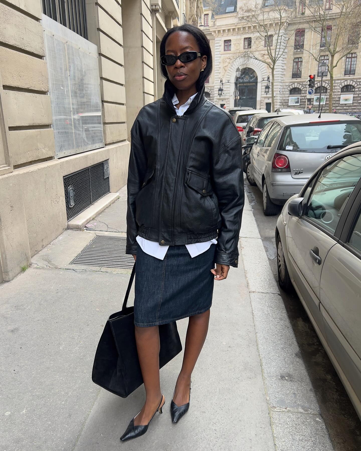 Sylvie Mus wearing a leather bomber jacket and a denim pencil skirt.