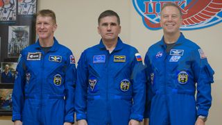 Expedition 46 Flight Engineer Tim Peake of ESA (European Space Agency), left, Soyuz Commander Yuri Malenchenko of the Russian Federal Space Agency (Roscosmos), center, and Flight Engineer Tim Kopra of NASA pose for a photo on Dec. 14, 2015 after a press conference at Baikonur Cosmodrome. The trio will launch to the International Space Station on Dec. 15.