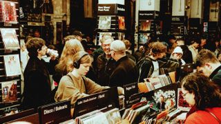 People browsing vinyl records and wearing headphones at Rough Trade store