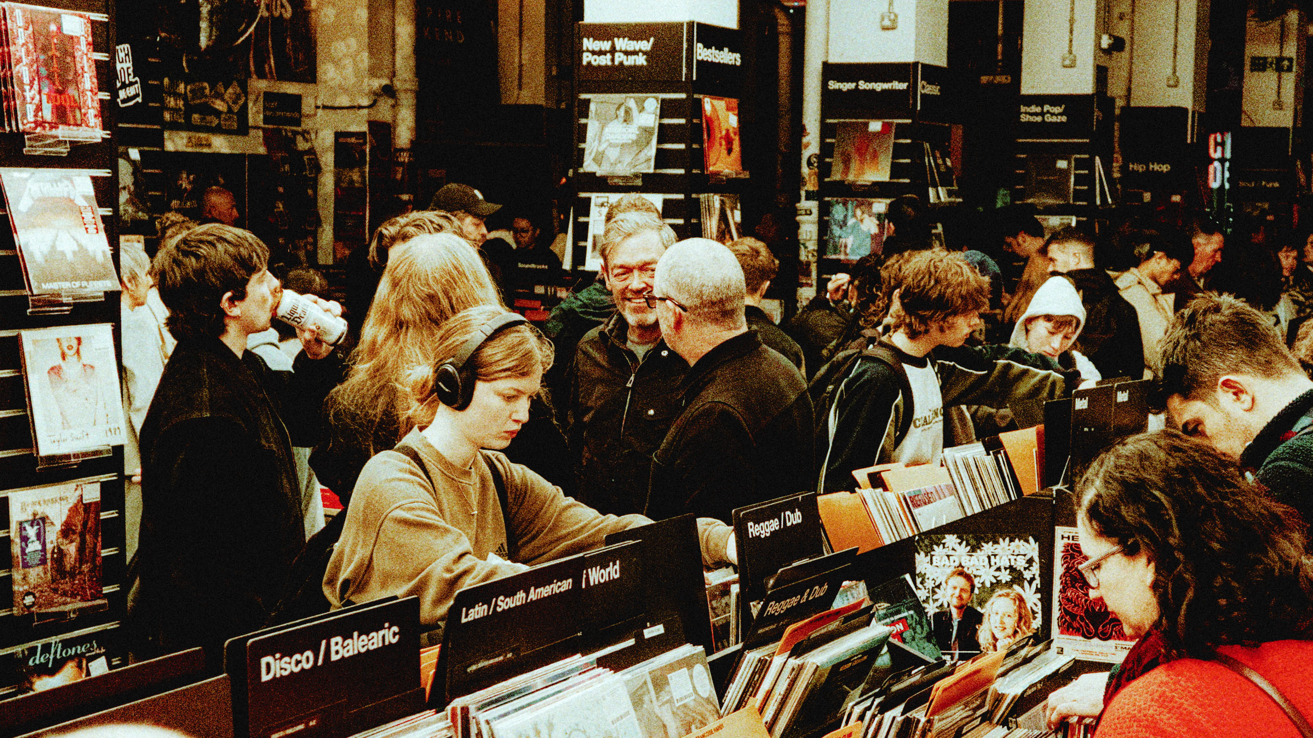 People browsing vinyl records and wearing headphones at Rough Trade store