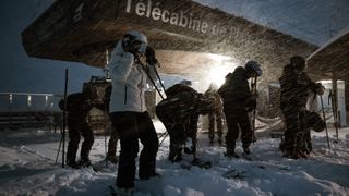 Skiers next to a lift station in Chamonix in a snowstorm