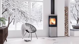 contemporary log burning stove in conservatory with snow outside
