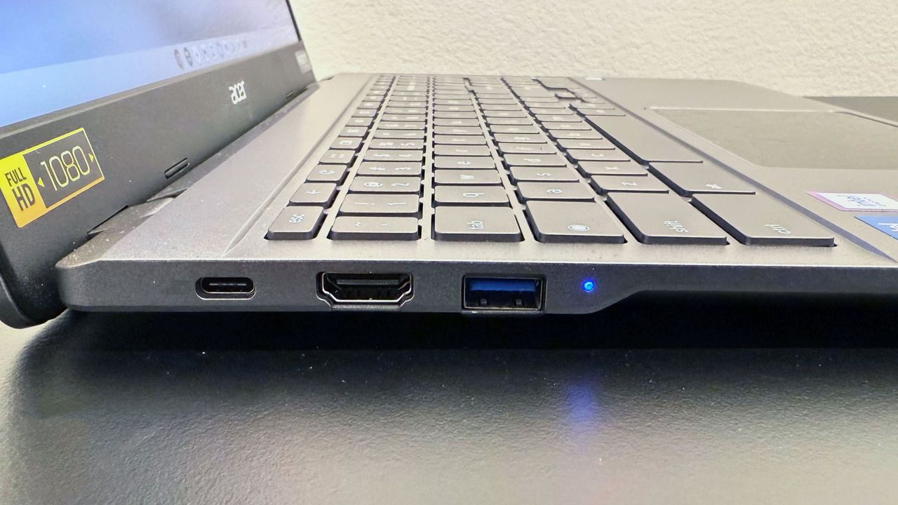Close up of the right-side ports on the Acer Chromebook Plus Enterprise 515, on a black desk against a white background.