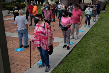 People wait in line to vote in Westchester, Florida.