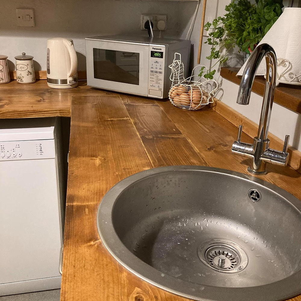 kitchen with sink wooden worktop and oven