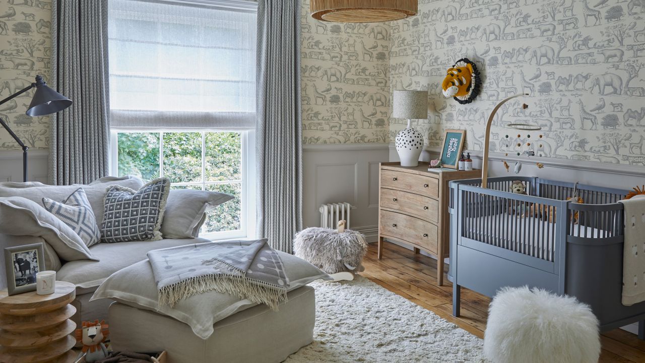 Gender neutral nursery with grey wallpaper and grey nursing chair