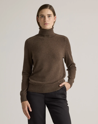 A model wearing a brown Quince turtleneck sweater