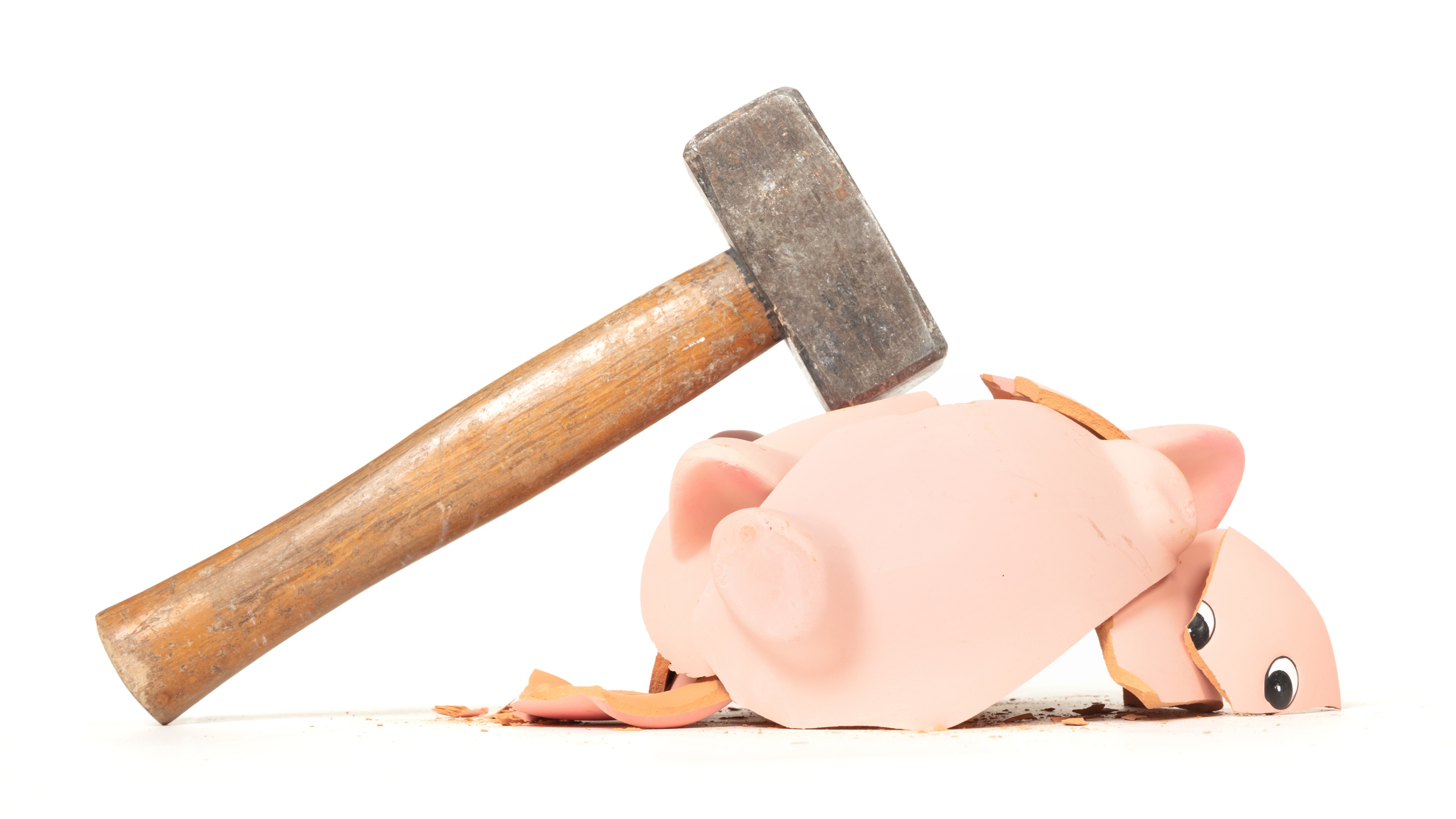 Hammer breaking a piggy bank.