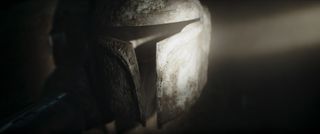 A dust-covered Mandalorian helmet The Mandalorian season 3 episode 2
