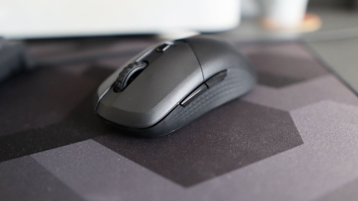 MSI Versa 300 Wireless 8K on a desk and held in a hand.