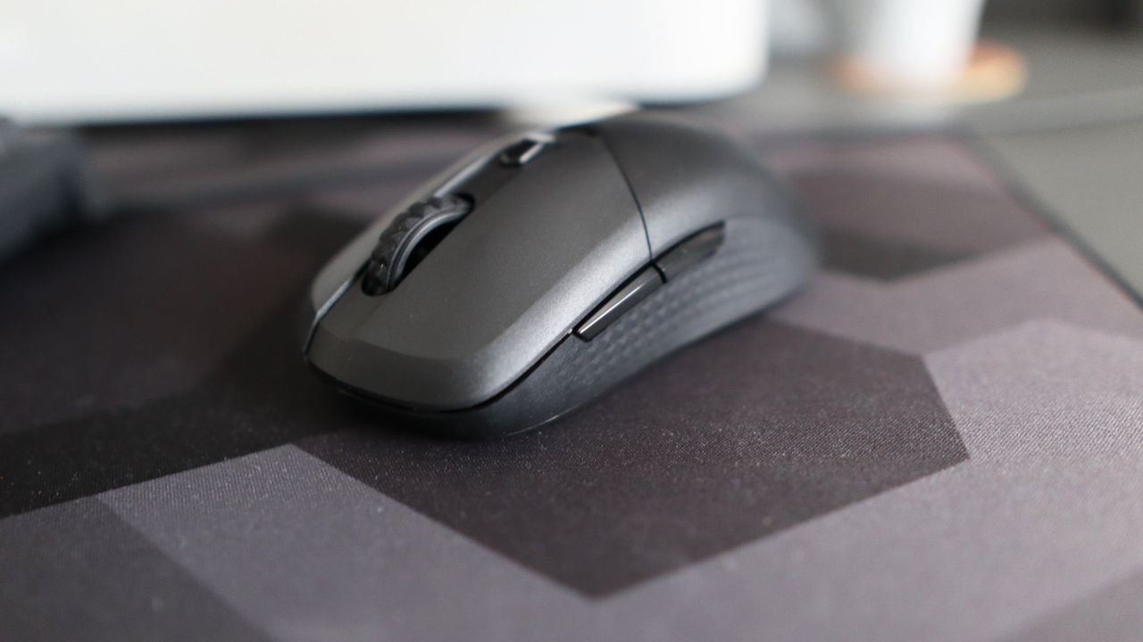 MSI Versa 300 Wireless 8K on a desk and held in a hand.
