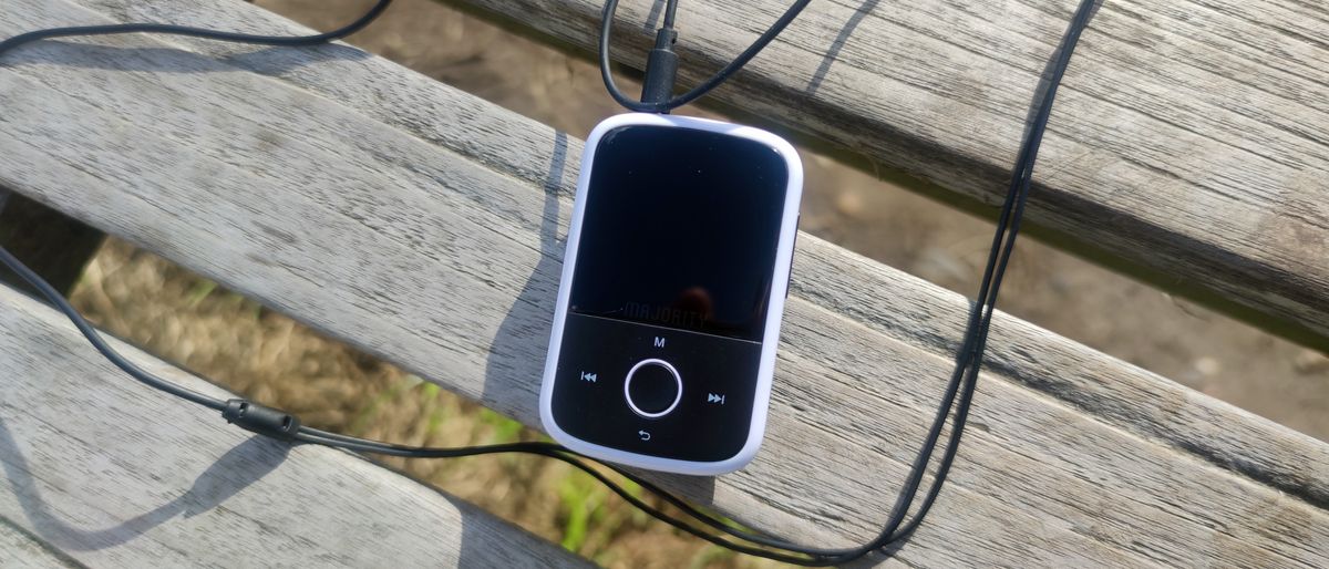 The Majority MP3 Player on a wooden bench.