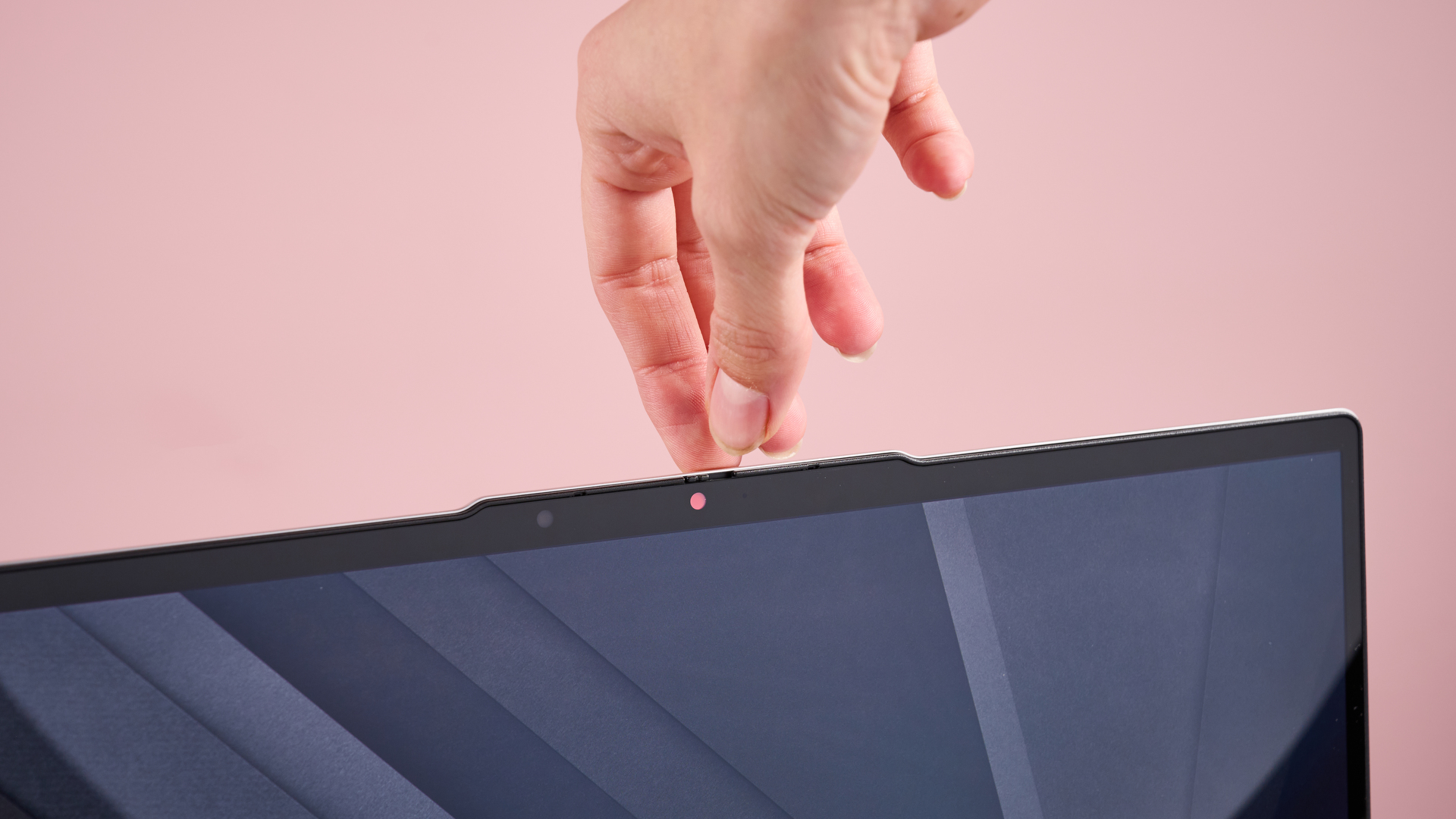Close-up of webcam on Lenovo Chromebook Plus 14-inch with hand touching the lid behind it