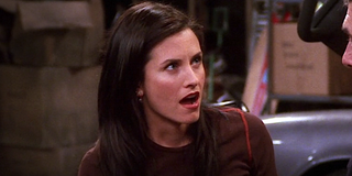 Friends Monica Courtney Cox reacts as Ross says something at their parents' house.