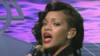 Rihanna performing in front of an animated green screen on SNL