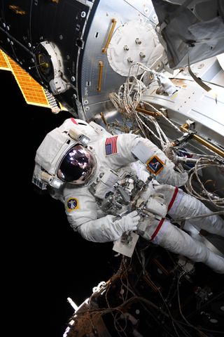 NASA astronaut Nick Hague sports an Artemis program logo during his spacewalk on Aug. 22, 2019.