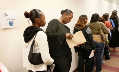 Job seekers wait in line to be interviewed at a job fair. 