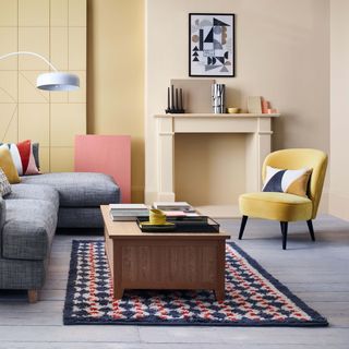 yellow armchair with rug and wooden table