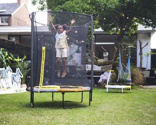 trampoline and child in small garden