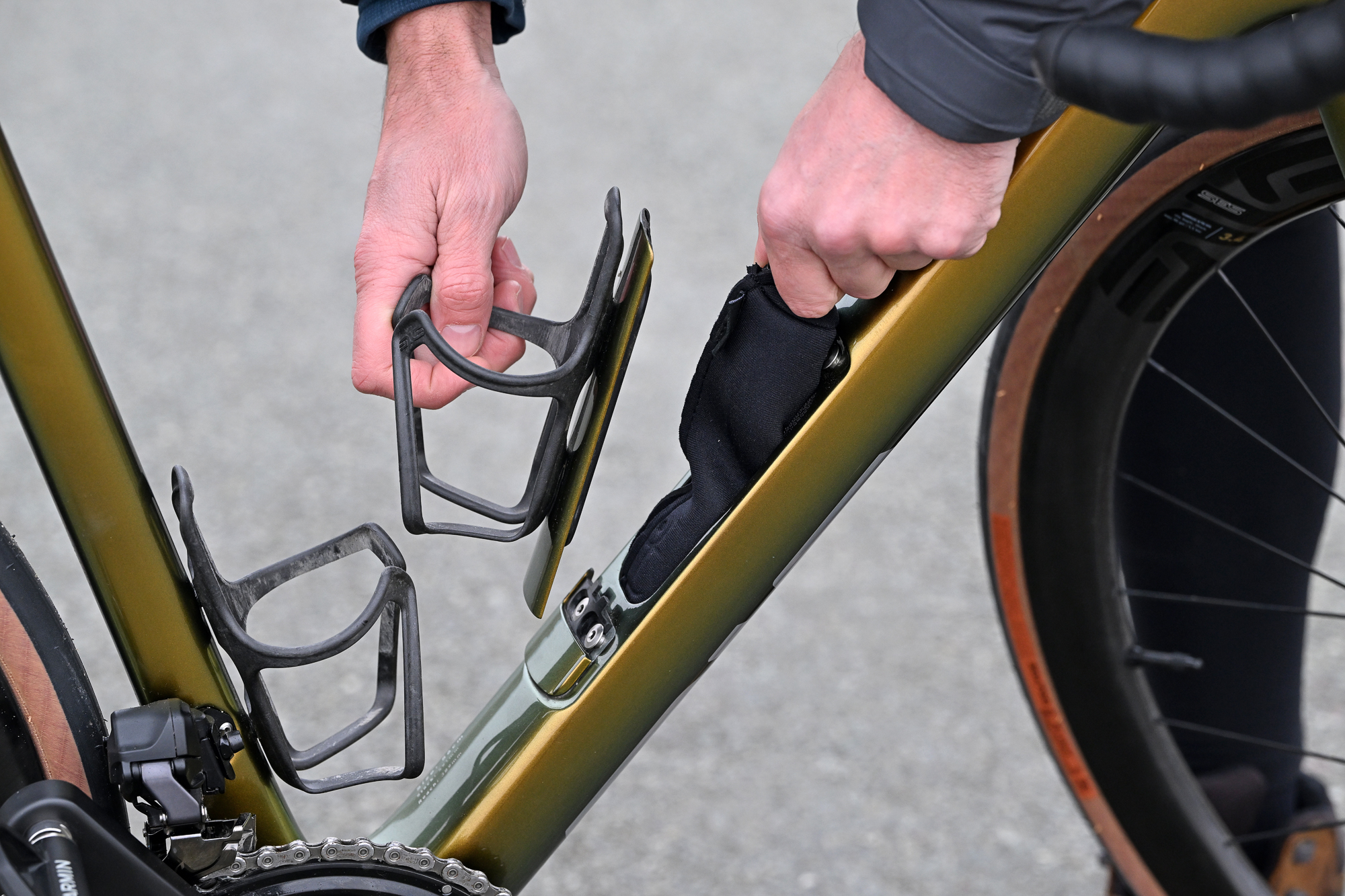 Man opening the down tube storage on the ENVE Fray bike