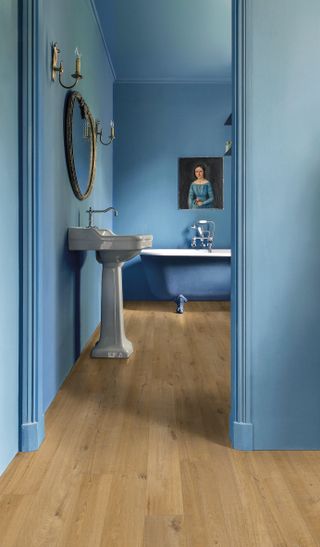 traditional flooring blue bathroom with bath and sinks