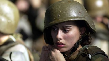 parris island, sc january 15 united states marine corps female recruit stephanie palladino adjusts her kevlar helmet january 15, 2003 before re entering the combat pool for another swim lesson during boot camp on parris island, sc under the watchful eyes of swim instructors, recruits are required to swim in full gear and learn limited strokes and breathing to stay afloat along with life saving techniques photo by stephen mortongetty images