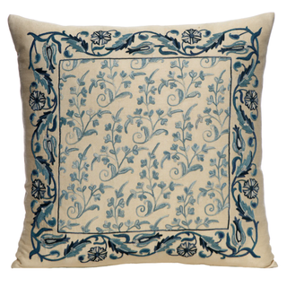 cream pillow with blue floral design